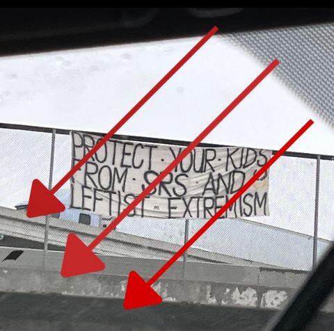 a banner on an overpass that says "protect your kids from SRS and leftist extremism"