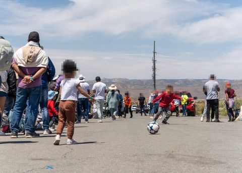 children play soccer on the road