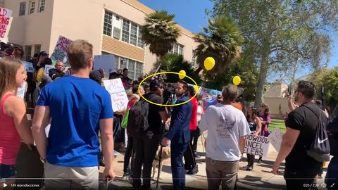 Youtube screenshot showing Nunez and Weber standing in the middle of a crowd of QAnon people in front of Hollywood High School.
