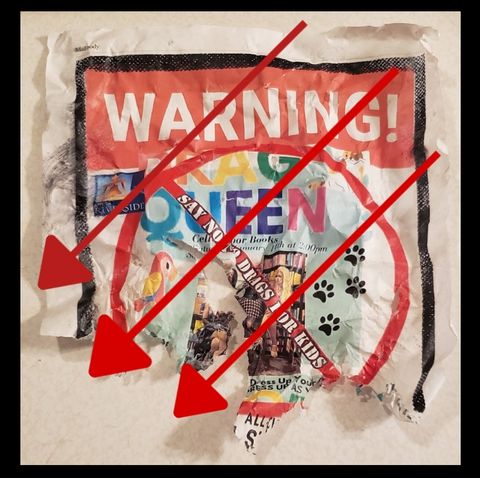 A torn up, waterlogged poster saying "warning! drag queen" and the rest of the poster is illegible