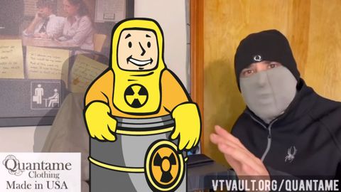 Felix is visible on the right side of the frame in a Quantame beanie and a Quantame gaiter. The middle of the frame has a Vault Boy from Fallout photoshopped into frame by LCRW. The Vault Boy is from the "Rad Resistant" perk. The Vault Boy is smiling in a thick radiation-proof suit, standing in a barrel of radioactive material.