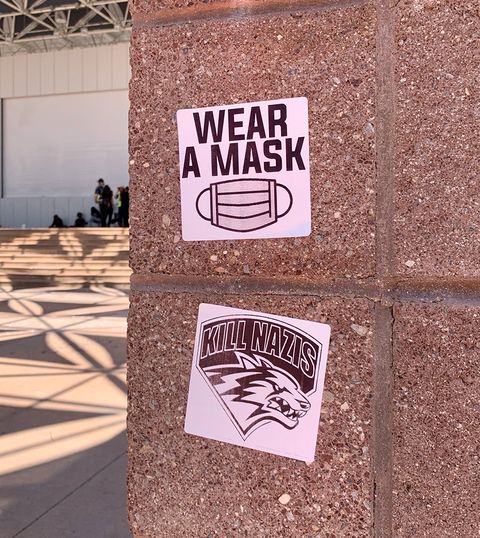 Stickers put up at the plaza on July 19. The bottom sticker transposes the phrase 'Kill Nazis' on the University of New Mexico lobos emblem.