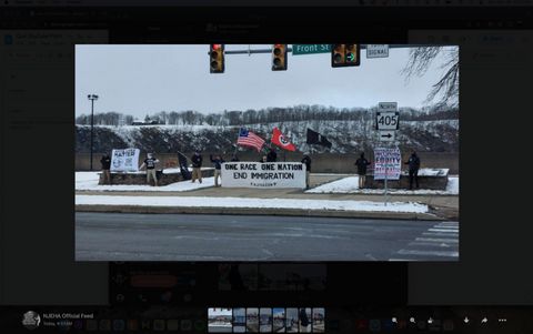 A screenshot from NJEHA Telegram channel, which shows photos posted from an action done by European Heritage Association, White Lives Matter Pennsylvania, Embrace Struggle Active Club, and Storm Division 14. The neo-nazi activists are shown rallying in Sunbury, PA, carrying a banner that reads “One race, one nation, End Immigration,” amongst other flags and banners. 