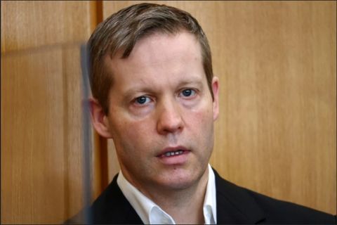 Stephan Ernst sitting in a courtroom close-up from his shoulders on up with a bewildered look on his face, mouth open slightly and eyes wide