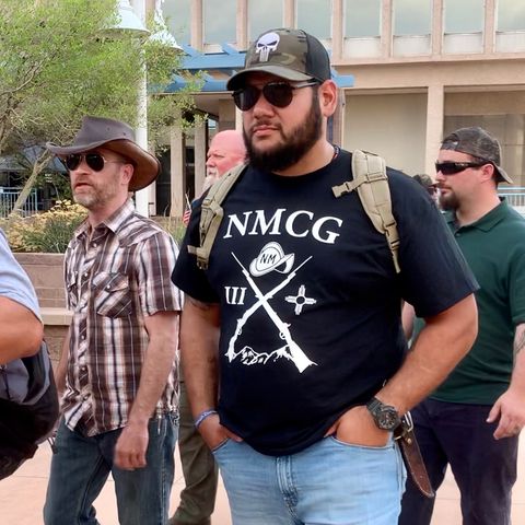 A member of the New Mexico Civil Guard wearing the racist militia's official t-shirt. Photo by Bella Davis.