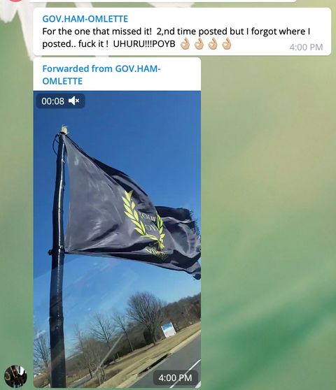 A user named 'GOV. HAM-OMLETTE', identified as Virginia Proud Boy Russell Hampton Ouelette, posts a video of a flying Proud Boys flag in the 'Patriot Party National ' channel. The attached post reads: 'For the one that missed it! 2,nd time posted but i forgot where I posted.. fuck it ! UHURU!!!POYB  '