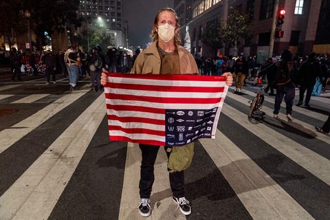 Ryan Miller poses for a photo at the 'Justice for Jacob' protest near the U.S. District Courthouse in Oakland, Calif., August 26, 2020. Just before several protesters went onto federal property to hit a door at the courthouse and were met with pepper ball fire from unknown officers.