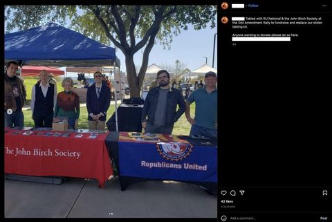 Screenshot from ASU-CRU’s instagram. Photo shows two booths at the 2A rally connecting to one another. One has a red tarp reading “The John Birch Society,” the other is draped with the blue Republicans United flag. 6 people stand and pose for a photo, including CRU founder Richard Thomas. Caption by the photo reads “Tabled with RU National and John Birch Society at the 2nd Amendment Rally to fundraise and replace our stolen tabling kid. Anyone wanting to donate please do so here”: (redacted by me). “42 likes.”