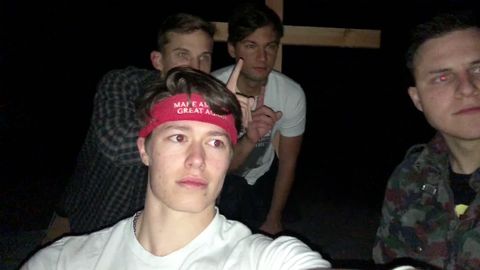 Ryan Sanchez (right) and Christian Secor (furthest back) along with two other unidentified Groypers pose with the wooden cross they raised in place of the Atascadero monolith