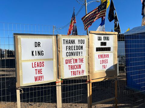 Protest signs that say 'Dr King leads the way, thank you freedom convoy give them the trucking truth, we are all truckers kingman loves ya'