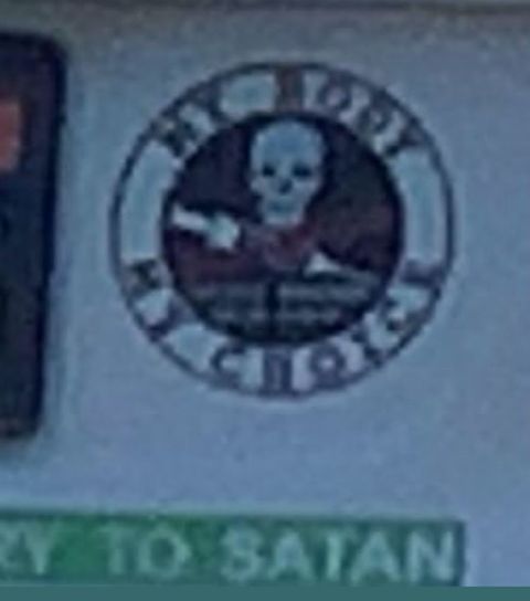 a sticker with a skull above a needle with the slogan 'my body, my choice' over it