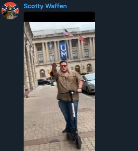 Josh Barham giving a Hitler salute while riding a scooter.