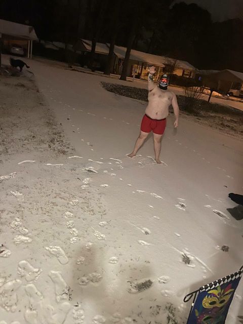 Josh Barham giving a Hitler salute while standing topless in the underwear in the snow wearing a skull mask.