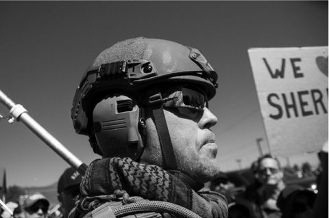 A member of a local militia provides crowd control for the Douglas County Sheriff at a Black Lives Matter Rally. Photo by JJ Mazzucotelli