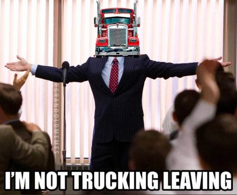 A meme of a man with a big rig truck for a head gesturing to an applauding crowd with the caption 'I'm not trucking leaving'