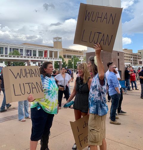 Anti-quarantine protesters carrying signs with the racist phrase 'Wuhan Lujan,' referencing New Mexico Governor Michelle Lujan Grisham. Photo by Bella Davis.