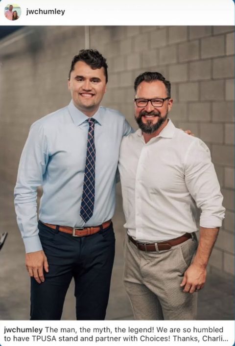 screenshot from Josh Chumley’s instagram (JWChumley) it’s a photo of Charlie Kirk in a light blue button up and navy blue suit pants with his arms around Josh Chumley wearing a white button up shirt and tan pants. Both are smiling and facing the camera. Text reads “The man, the myth, the legend! We are so humbled to have TPUSA stand and partner with Choices! Thanks, Charlie.”
