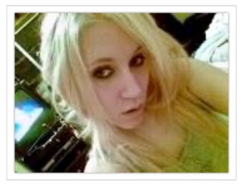 An image showing Dallas Humber posing for a selfie. She appears very young in the photo. Her hair is platinum blonde and long, and she is wearing very thick black eyeliner on her upper lids and below her waterline.